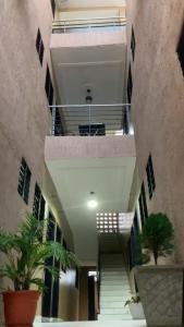 a hallway of a building with stairs and potted plants at La MAISON SEONE STANDARD in Abidjan +4 photos