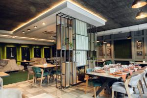 a restaurant with tables and chairs in a room at HOUSE silver in Ivano-Frankivsk