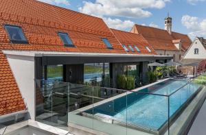 an external view of a house with a swimming pool at Hotel Maximilian’s in Augsburg
