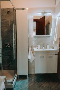 a bathroom with a sink and a shower at Tina's Resident in Igoumenitsa +26 photos