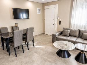 a living room with a couch and a table at Katsanikos Apartments in Prinos