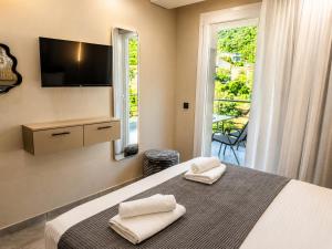 a bedroom with a bed with two towels on it at Katsanikos Apartments in Prinos