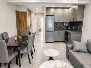 a kitchen and living room with a table and a couch at Katsanikos Apartments in Prinos