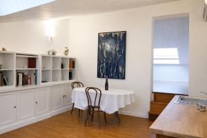 a kitchen with a table and chairs and a window at Casa Olgaluna - Art Home in La Spezia