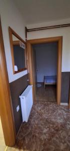an empty room with a door and a room with a bench at Apartman SAVKA in Gornji Ribnik +2 photos