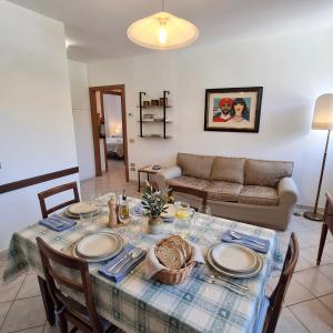 a living room with a table and a couch at Casa Stella in Sarnano +11 photos