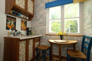 a kitchen with a small table and a window at Türi Puhkemaja - Murunella in Türi