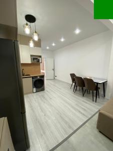 a kitchen and dining room with a table and chairs at SF Residence in Bosteri +6 photos