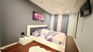a bedroom with a bed and a tv on the wall at RIVABeach House in Lourinhã +17 photos