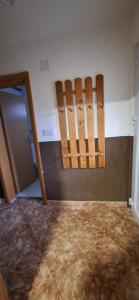 a room with two wooden chairs and a wall at Apartman SAVKA in Gornji Ribnik