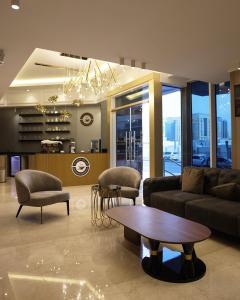 a living room with a couch and a table at Al Mansour Plaza Hotel in Doha