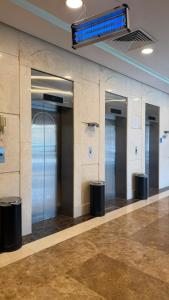 a row of elevators in a building with a wall at Miaad Al Majd Hotel in Mecca