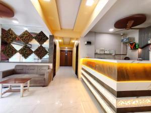 a lobby of a restaurant with a bench and a bar at Hotel Sagar Residency in Panvel