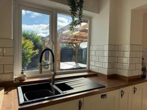 a kitchen counter with a sink and a window at Nordic Spa House in Brandon