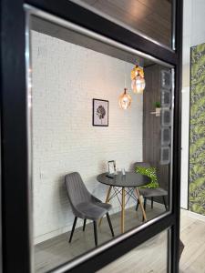 a dining room with a table and two chairs at Zest hotel & spa in Oral