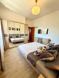 a bedroom with a large bed and a mirror at Casa Gemelli in San Fedele Intelvi
