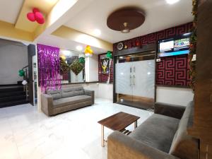 a living room with couches and a table at Hotel Sagar Residency in Panvel