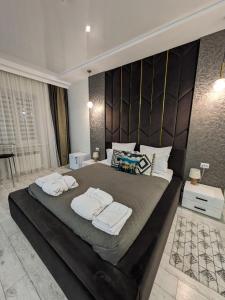 a bedroom with a large bed with towels on it at Zest hotel & spa in Oral +78 photos