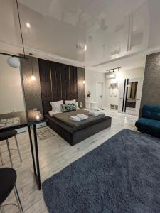 a bedroom with a bed and a living room at Zest hotel & spa in Oral