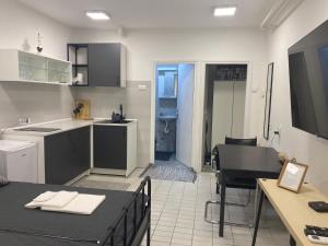 a kitchen with a sink and a table and a kitchen with a stove at Dona1102 in Žarkovo