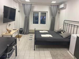 a bedroom with a bed and a flat screen tv at Dona1102 in Žarkovo