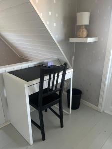 a desk with a chair and a desk underneath a staircase at Villa Martini in Åmål +21 photos