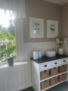 a kitchen with a white cabinet and a window at Villa Martini in Åmål