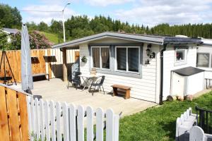 a wooden deck next to a white fence at Visit Senja Lady in Senja
