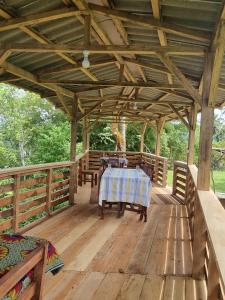 a wooden pavilion with a table on a deck at Pousada Vila Paraíso in Santa Cruz