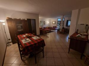 a living room with a table and a couch at La Casa Dei Boschi in San Marino