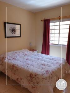 a bedroom with a bed and a window at SAN TAURO VIEDMA in Viedma