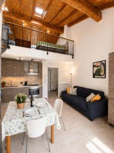 a living room with a table and a couch at Lilly House Perfect stopover near Lake Como Switzerland and Milan in Fino Mornasco