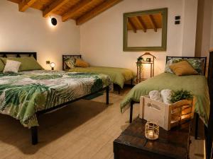 a bedroom with two beds and a mirror on the wall at Lilly House Perfect stopover near Lake Como Switzerland and Milan in Fino Mornasco