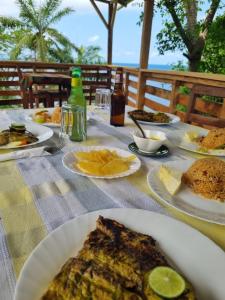a table with plates of food on a table at Pousada Vila Paraíso in Santa Cruz +51 photos