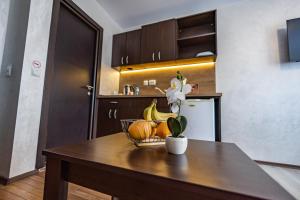 a kitchen table with a bowl of fruit and a flower at Snow Crystal Studio in Bansko