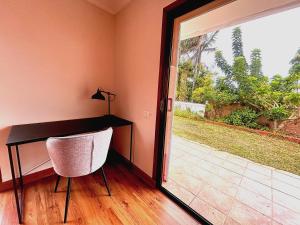 a desk with a chair next to a sliding glass door at Villa Casa Papaya - All Year Heated Pool in La Orotava
