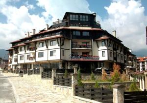 a large white building on the side of a street at Snow Crystal Studio in Bansko