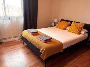 a bedroom with a bed with two towels on it at Villa Casa Papaya - All Year Heated Pool in La Orotava