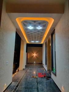 a hallway with a ceiling in a building at Savadhani Palace in Govardhan