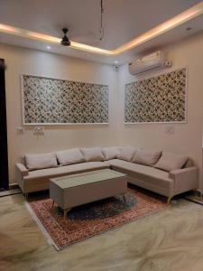 a living room with a couch and a coffee table at Savadhani Palace in Govardhan