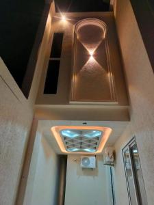 a room with a door with a ceiling with lights at Savadhani Palace in Govardhan