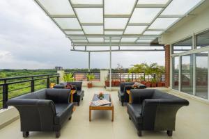 a living room with couches and a table at R D Hotels HSR in Bangalore