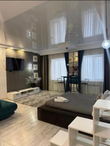 a bedroom with a large bed and a living room at Zest hotel & spa in Oral