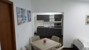 a small white kitchen with a table and chairs at Beach Paradise Apartments in San Andrés +11 photos