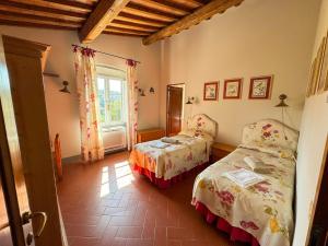 a bedroom with two beds and a window at Fattoria di Maiano in Fiesole +59 photos
