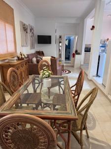 a living room with a glass table and chairs at Finca Los Olivos & spa, animaux in Utrera +12 photos