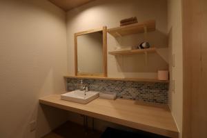 a bathroom with a sink and a mirror at Yanagawa B&B hatago in Yanagawa