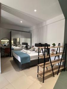 a bedroom with two bunk beds and a mirror at Summer Dream Escape Apartment in Gerakini