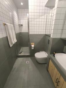 a bathroom with a shower and a toilet and a sink at Summer Dream Escape Apartment in Gerakini +15 photos