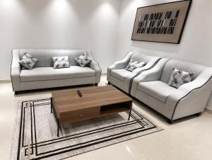 a living room with two couches and a coffee table at أرياف سويت in Al Baha